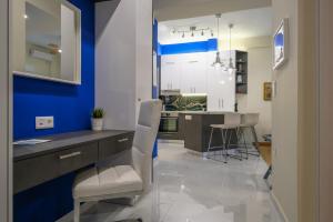 a blue and white kitchen with a table and chairs at Piraeus 4th floor in Piraeus