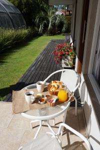 a tray of breakfast food on a table on a patio at Aqualina Suites in Valeria del Mar