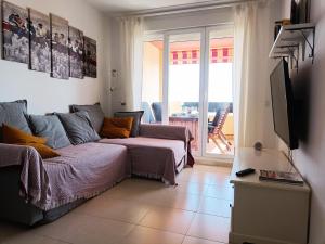 a living room with a couch and a tv at La Terraza del Gallopedro in Vera
