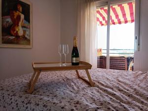 a bottle of wine and two wine glasses on a bed at La Terraza del Gallopedro in Vera +23 photos