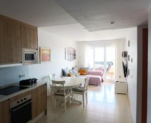 a kitchen and living room with a table and chairs at La Terraza del Gallopedro in Vera