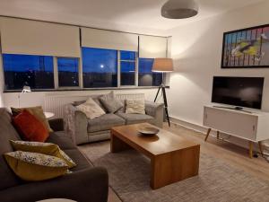 a living room with a couch and a coffee table at Newly renovated apartment! in London