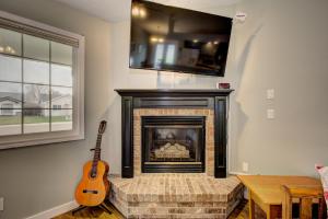 a living room with a fireplace and a guitar at Hello Dolly! 3 beds, 2 bath, 2 TV's, Fireplace, Quiet Neighborhood in Star, ID minutes from walking trails and river views in Eagle