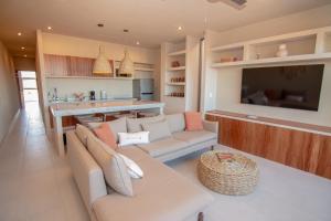 a living room with a couch and a television at Evamar San Carlos in San Carlos