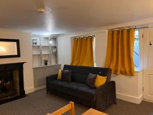 ein Wohnzimmer mit einem Sofa und einem gelben Vorhang in der Unterkunft Entire 2-bedroom Flat in Camden in London