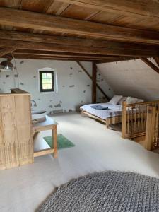 a bedroom with a bed and a table in a room at Luxury stay in 250 year old wine farm house and gardens in Rüschlikon