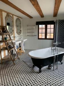 a large bathroom with a tub and two sinks at Luxury stay in 250 year old wine farm house and gardens in Rüschlikon