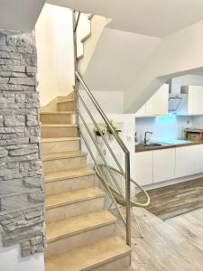 a staircase in a house with a stone wall at Holiday Home Maria one minute from -Beach in Zadar