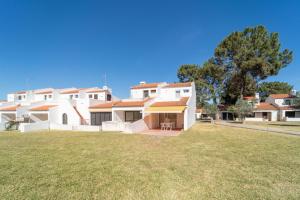 a large yard in front of a white house at Villa Alfamar by HelloVacations in Albufeira