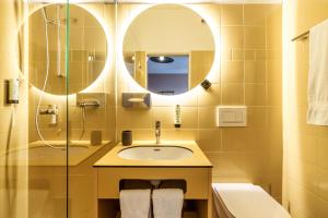 a bathroom with a sink and a mirror at Kloster by b-smart in Schaan