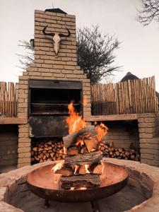 a fire pit with a bull head on a brick oven at Milkwood Valley Lodge, Mabalingwe in Bela-Bela