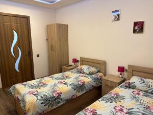 a bedroom with two beds and a door at Nice in Akhaltsikhe