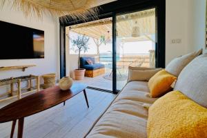 a living room with a couch and a table at Maison bohème au bord de l'eau in Sète