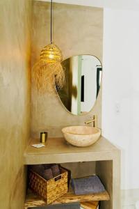 a bathroom with a sink and a mirror at Maison bohème au bord de l'eau in Sète