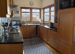 a kitchen with a sink and a counter top at Luxury Seaside Home with Incredible Views in Fife