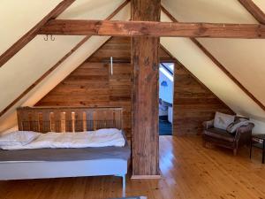 ein Schlafzimmer mit einem Bett im Dachgeschoss in der Unterkunft Navröds Gård in Sjöbo