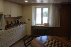 a small kitchen with a table and a window at Chez Ginette et Jean-François in Le Chenit