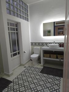 a bathroom with a toilet and a sink and a mirror at LAU APP VICTOR CENTRE VILLE in Rabat +18 photos