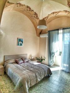 a bedroom with a large bed in a room at Casa Antonella in Acireale