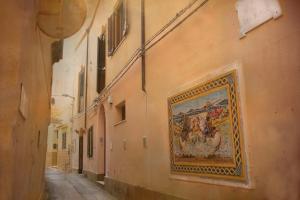 an alley with a painting on the side of a building at Kasbah Apartment in Mazara del Vallo