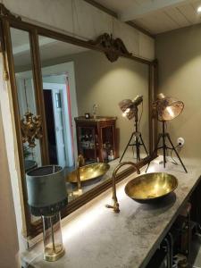 a bathroom with two sinks and a large mirror at Mojo organic spa in Borgholm