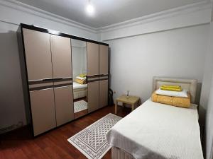 a small bedroom with a bed and a large mirror at Cozy Apartment in Kadikoy in Istanbul
