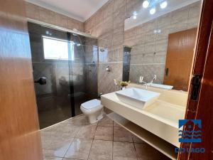 a bathroom with a sink and a shower and a toilet at Hostel do Lago in Sao Jose do Rio Preto