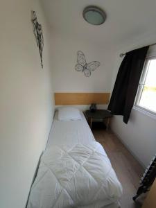 Le Cocooning في Biville-sur-Mer: غرفة نوم مع سرير في غرفة مع نافذة
