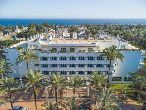 an aerial view of a hotel with palm trees and the ocean at Alanda Marbella Hotel & Wellness in Marbella +85 photos