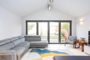 a living room with a couch and a table at The Art House by Sorted Stay in Woodham Ferrers