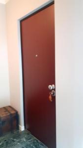 a brown door with a handle in a room at lo Tsanty in Aosta