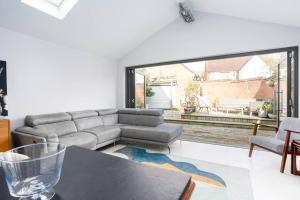 a living room with a couch and a table at The Art House by Sorted Stay in Woodham Ferrers