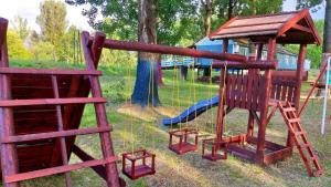 a park with a playground with a slide at Rakamaz Tisza Kemping in Rakamaz