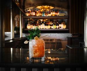 a drink sitting on a table in a bar at The Georgian Hotel in Los Angeles