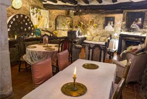 a dining room with two tables and a candle on it at CASA NOTARI - Casa Rural Zona Congost de Montrebei in Tolva