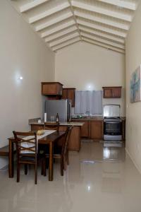 a large kitchen with a table and chairs in it at Entire residential home • Trelawny• Smalls Villa in Florence Hall