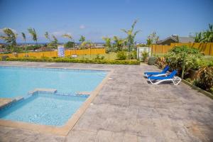 a swimming pool with two lounge chairs next to it at Entire residential home • Trelawny• Smalls Villa in Florence Hall