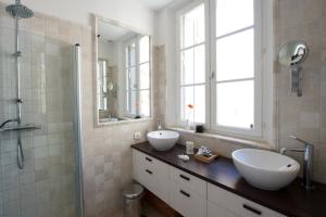 a bathroom with two sinks and a shower at Rue Sade Bed & Breakfast in Antibes