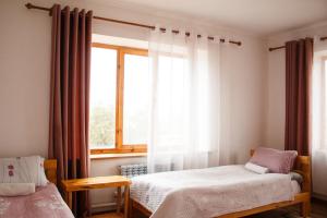 Postel nebo postele na pokoji v ubytování Guest House Altyn Oimok