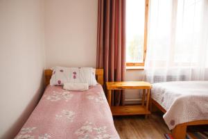 Postel nebo postele na pokoji v ubytování Guest House Altyn Oimok