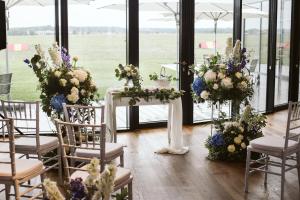 a room with a table with chairs and flowers at MG Restaurace/Luxury Apartments in Mladá Boleslav