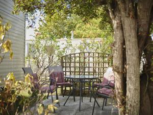 una mesa y sillas en un patio en Lighthouse Holiday Retreat, en West Mersea