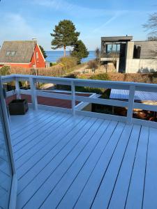 a deck with a view of the ocean at feriehus med havudsigt in Spodsbjerg