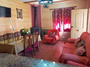 a living room with a couch and a table and chairs at El Ventorrillo 1 in Riópar