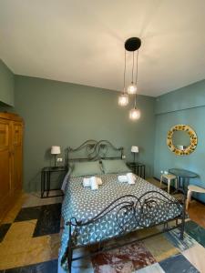 1 dormitorio con 1 cama con paredes azules y espejo en Delle Rose Rooms, en Verona