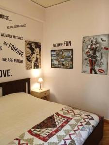 una camera da letto con un letto con poster appesi al muro di Still got the blues ad Atene