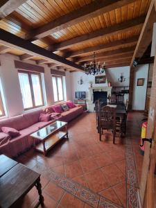 a living room with a couch and a table at Casas Rurales TIO CLAUDIO I y II in El Barraco