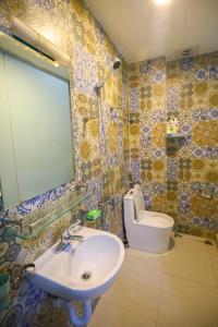 a bathroom with a sink and a toilet at Radish Cathedral Homestay in Hanoi