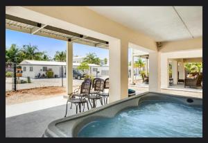 a swimming pool in the backyard of a house at Florida Keys Wellness Gem in Marathon