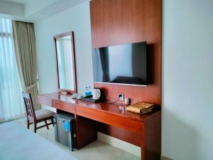 a desk in a hotel room with a mirror at DESHA TARC in Kushtia